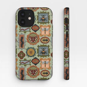 May include: A sage green phone case featuring a repeating pattern of various insects and arachnids, including bees, dragonflies, butterflies, ants, and centipedes, each displayed within individual ornate, colorful, and decorative picture frames.