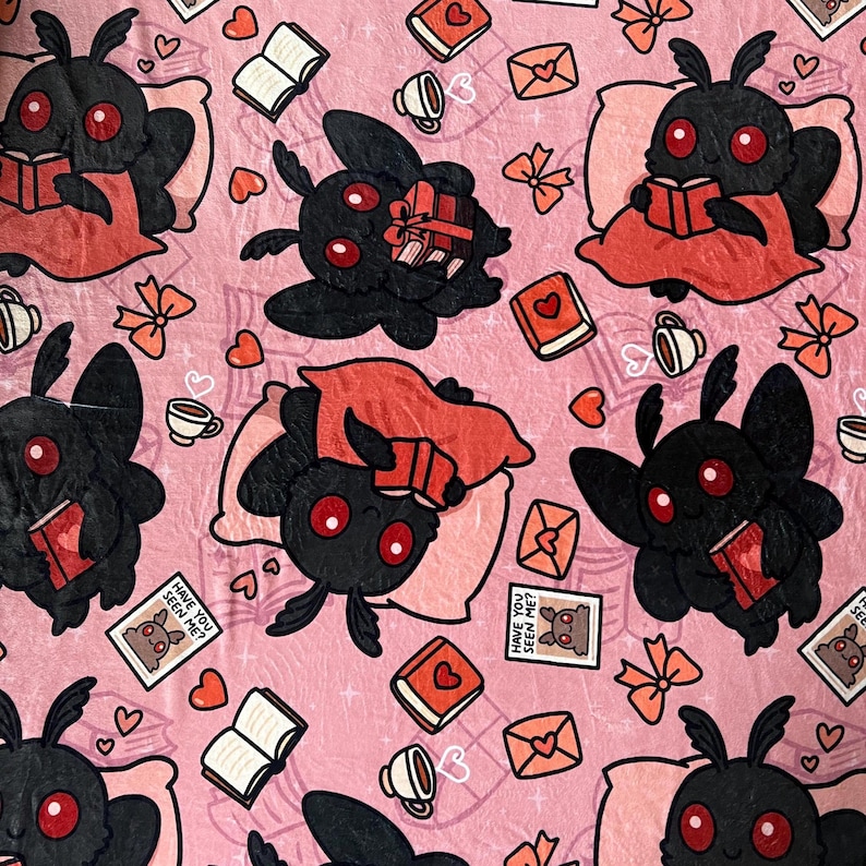 May include: Pink fabric with a repeating pattern of black moths reading books, hearts, and the text "Have you seen me?"