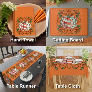 May include: A set of orange and brown kitchen linens featuring a stylized pumpkin design with fall foliage. The set includes a hand towel, cutting board, table runner, and tablecloth.