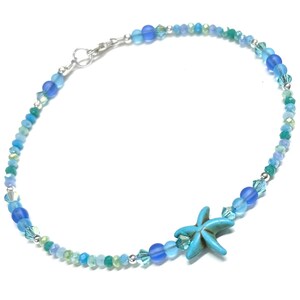May include: A delicate blue and green beaded anklet with a turquoise starfish charm. The anklet is made with glass beads and silver accents.