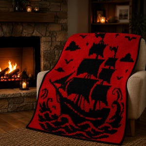 May include: A rectangular crochet blanket featuring a bold red background with a large black pixelated sailing ship design. The ship is depicted amidst black waves, with black clouds, birds, and stars scattered across the red field.