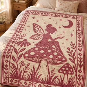 May include: A rectangular crochet blanket featuring a deep red and cream color scheme. The design displays a central fairy sitting on a large mushroom, surrounded by smaller mushrooms, flowers, stars, and a crescent moon, all framed by a floral border.