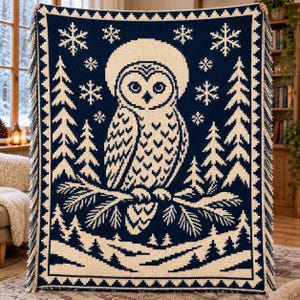 May include: A rectangular navy blue and cream crochet blanket featuring a central owl perched on a pine branch. The design includes surrounding pine trees, falling snowflakes, and a decorative border with fringe on the left and right sides.