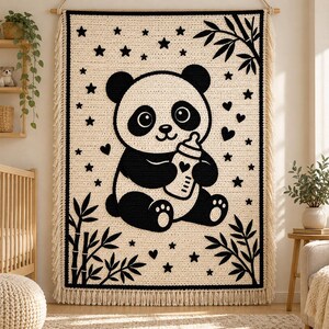 May include: A rectangular crochet wall hanging featuring a cream-colored background with a large black panda bear holding a baby bottle. The design includes black stars, hearts, and bamboo stalks in the corners, finished with fringe.