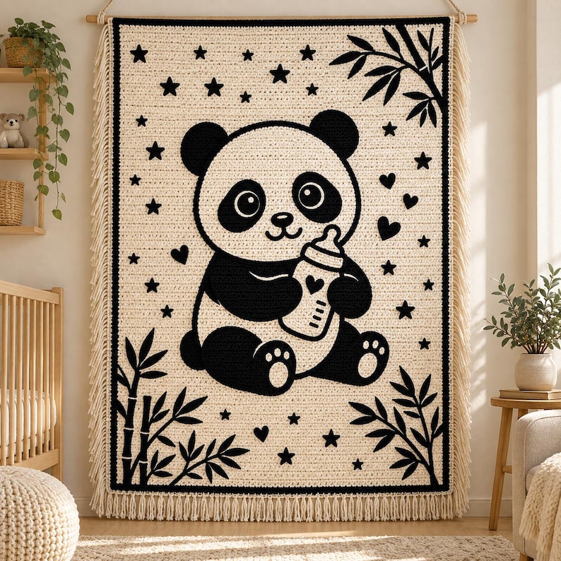 May include: A rectangular crochet wall hanging featuring a cream-colored background with a large black panda bear holding a baby bottle. The design includes black stars, hearts, and bamboo stalks in the corners, finished with fringe.