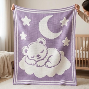 May include: A rectangular crochet blanket featuring a lavender purple background with a white border. The design displays a white sleeping bear resting on a cloud, accompanied by a large crescent moon and three stars in the upper section.