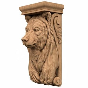 May include: A wooden bear-shaped corbel, featuring a detailed carving of a bear's head and upper body. The corbel has a rectangular top and decorative scrollwork on the side, showcasing a natural wood grain finish.