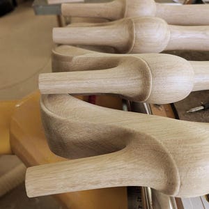 May include: A set of unfinished light-colored wooden furniture legs featuring a rounded bulbous top section and a tapered lower shaft. A metal ruler is visible along the side, showing measurements in centimeters starting from 41 to 46 centimeters.