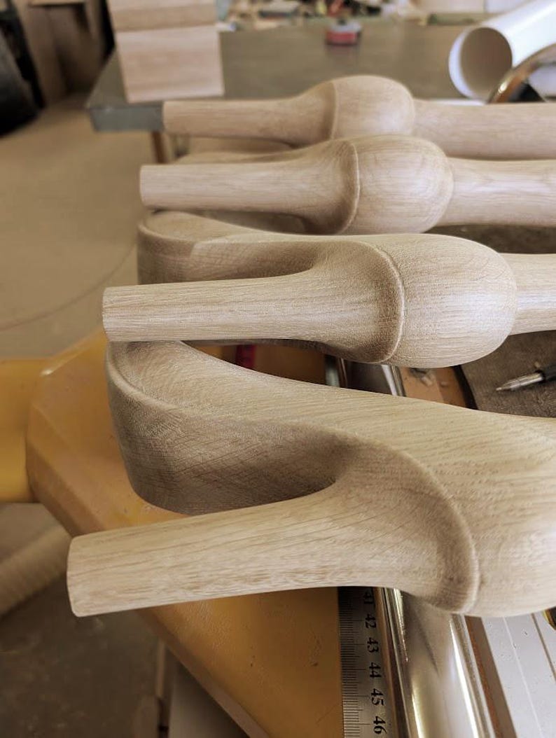 May include: A set of unfinished light-colored wooden furniture legs featuring a rounded bulbous top section and a tapered lower shaft. A metal ruler is visible along the side, showing measurements in centimeters starting from 41 to 46 centimeters.