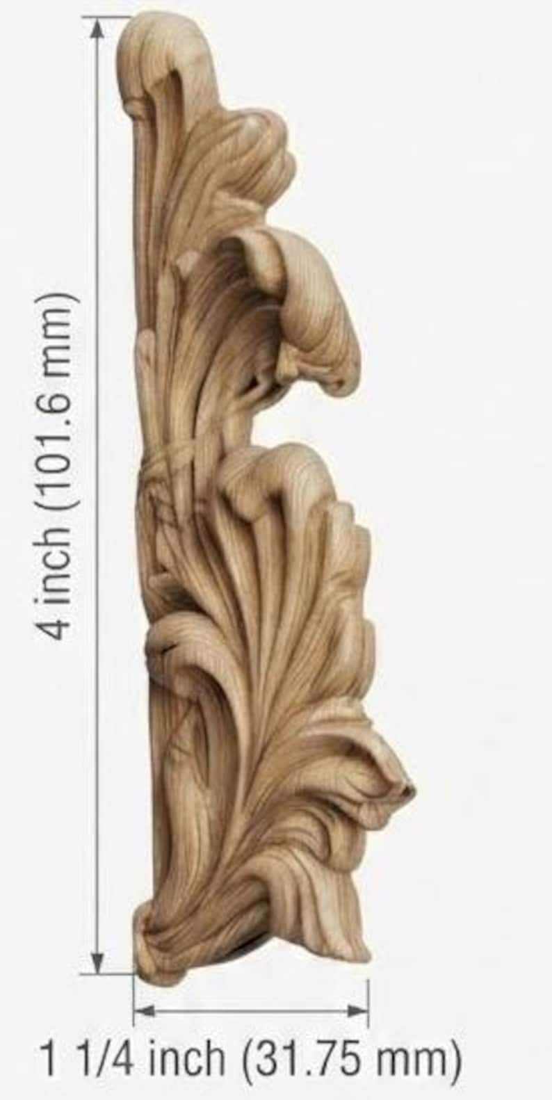 May include: A light brown wooden carving featuring an intricate acanthus leaf design. The piece measures 4 inches in height and 1 1/4 inches in width, as indicated by the measurement lines and text printed on the image.