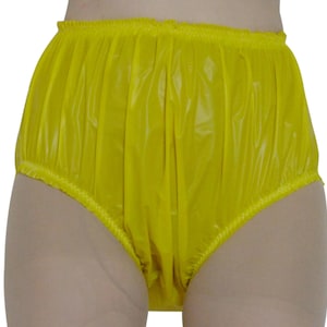 May include: Yellow plastic underwear with a gathered elastic waistband.