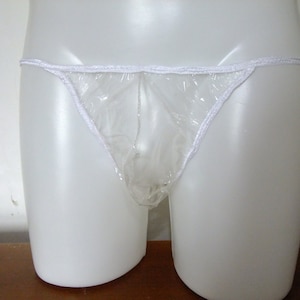 May include: Clear plastic underwear with white elastic trim. The underwear is on a white mannequin.