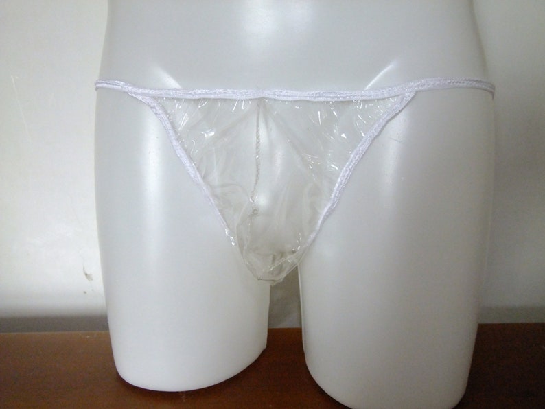May include: Clear plastic underwear with white elastic trim. The underwear is on a white mannequin.