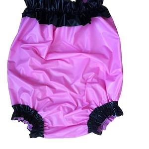 May include: A white ceramic mug with a black handle and the text "But First, Coffee" in a black, handwritten-style font. The mug is on a white surface.