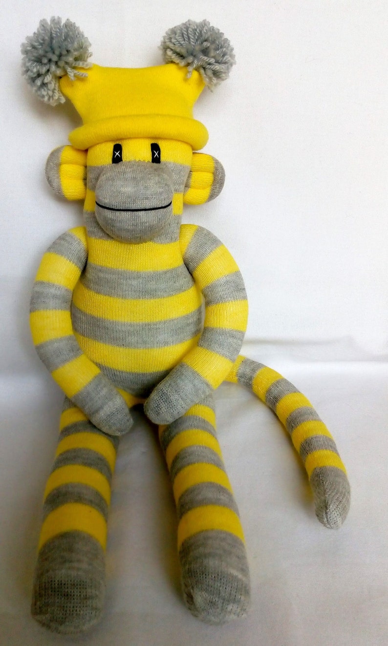 Yellow and Grey Sock Monkey with removable pom pom hat.