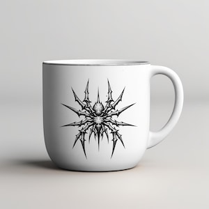 May include: White ceramic mug featuring a detailed black and gray spider design. The spider illustration has sharp, spiky appendages radiating outwards. The mug has a simple, clean design with a white background and a curved handle.