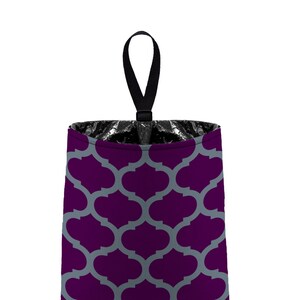 May include: A purple and gray patterned trash can with a black handle. The trash can is made of fabric and has a geometric design.