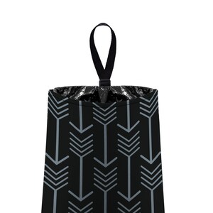 May include: A black fabric trash can with a gray arrow pattern and a black hanging loop.