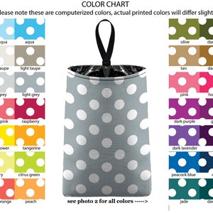 May include: Color chart showing 20 different colors of fabric with white polka dots. The colors are arranged in rows of two, with each color having a name below it. The chart is next to a gray fabric bag with white polka dots and a black handle.