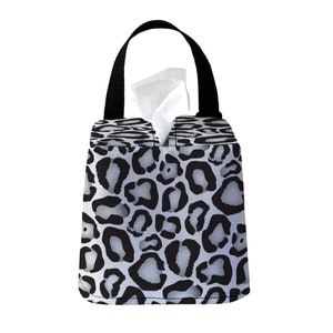 May include: A black and white leopard print tissue box cover with a black handle.