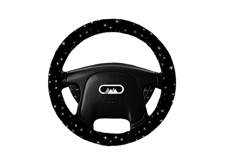May include: Black steering wheel cover with a white star pattern.