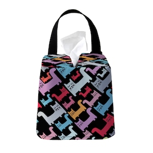 May include: A black tissue box cover with a colorful pattern of cats. The cover has a handle and is made of fabric.