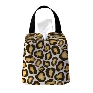 May include: A black tissue box holder with a leopard print design. The holder has a black handle and a white tissue box inside.