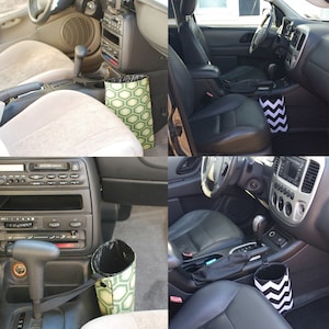 May include: Two car interiors with a black and white chevron patterned trash can and a green and white geometric patterned trash can. The trash cans are hanging from the gear shift.