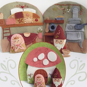 May include: A felt craft scene featuring a mushroom house and a kitchen with gnomes and a girl. The mushroom house has a red cap and a brown door. The kitchen has a stove, pots, and pans. The gnomes wear red hats and have white beards. The girl wears a pink headscarf.