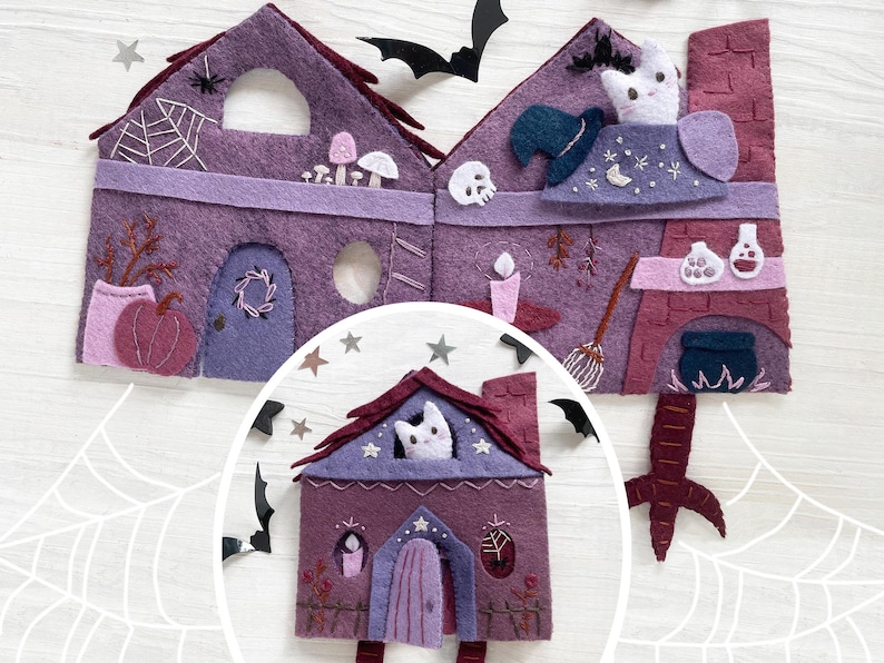 May include: A felt Halloween-themed house in shades of purple and burgundy. The house features a pumpkin, a spiderweb, a cat, a witch's hat, and other spooky decorations. The house is decorated with stars, bats, and a witch's broom.