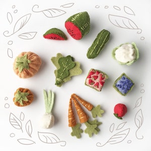 May include: A selection of felt food items, including a watermelon slice, cucumber, cauliflower, pumpkin, lettuce, strawberry square, blueberry square, carrot, radish, and a strawberry. The items are in various shades of green, red, orange, and white.