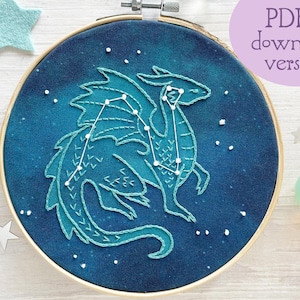 May include: Embroidered hoop art featuring a blue dragon constellation on a dark blue background with white stars.  The PDF download version is available.