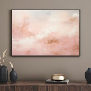 May include: Abstract painting with a pink, white, and gold color scheme. The painting depicts a cloudy sky with soft, blended brushstrokes.