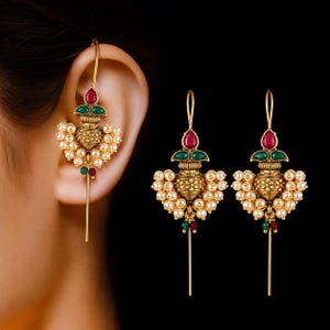 May include: A pair of gold-toned drop earrings featuring a central pot-shaped motif with an antique finish. Each earring is adorned with a teardrop-shaped red stone, two green stones, and clusters of small white pearls, finished with a long metal pin.