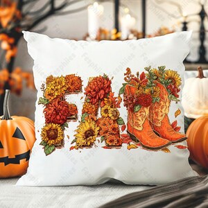 May include: White cushion featuring the word "FALL" crafted from orange and yellow flowers and leaves. Two orange cowboy boots, filled with flowers, are also depicted. Pumpkins and autumn foliage are in the background.
