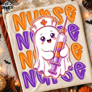May include: A cream-colored t-shirt featuring a cartoon ghost wearing a nurse cap and holding a syringe filled with orange liquid. The background text repeats the word NURSE in large, bold, orange and purple bubble letters across the fabric.