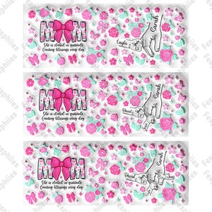 May include: A set of three clear rubber stamps with pink and green floral designs. The stamps feature the word "MOM" with a pink bow, and the text "She is clothed in gratitude, Counting blessings every day". The stamps also include the names "Sarah", "David", "Jessi", and "Cayla" in a handwritten font.