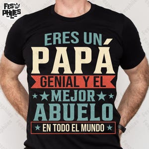 May include: Black t-shirt with the text "ERES UN PAPÁ GENIAL Y EL MEJOR ABUELO EN TODO EL MUNDO" in cream, red, and teal lettering. The shirt has a crew neck and short sleeves.