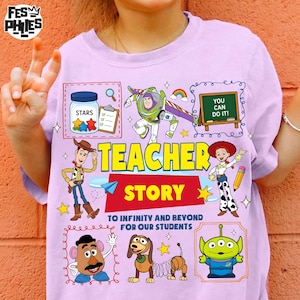 May include: A light purple t-shirt featuring cartoon characters and the text "TEACHER STORY". The design includes images of Buzz Lightyear, Woody, and other characters, with the phrase "TO INFINITY AND BEYOND FOR OUR STUDENTS".