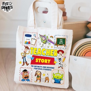 May include: A cream-colored canvas tote bag featuring colorful illustrations of characters from the movie Toy Story. The bag has the words "TEACHER STORY" and "TO INFINITY AND BEYOND FOR OUR STUDENTS" printed on it. The bag has a rectangular shape with a handle.