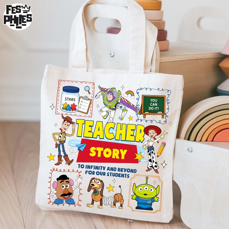 May include: A cream-colored canvas tote bag featuring colorful illustrations of characters from the movie Toy Story. The bag has the words "TEACHER STORY" and "TO INFINITY AND BEYOND FOR OUR STUDENTS" printed on it. The bag has a rectangular shape with a handle.