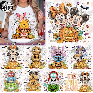 May include: White t-shirt featuring a colorful Halloween-themed graphic. The design includes Winnie the Pooh, Tigger, and Piglet, along with pumpkins, ghosts, and spiderwebs. Additional graphics show Mickey and Minnie Mouse, Stitch, and other characters.