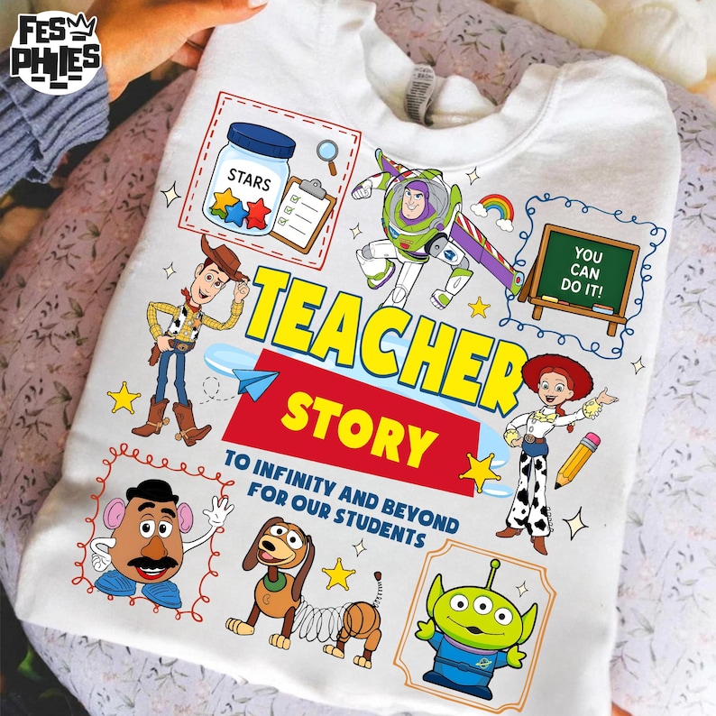 May include: White sweatshirt featuring colorful cartoon characters and the words "Teacher Story." The design includes images of a jar of stars, Buzz Lightyear, Woody, Jessie, and other Toy Story characters. The text "To Infinity and Beyond for Our Students" is also included.