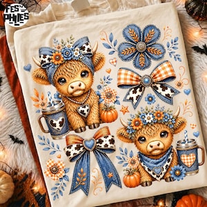 May include: A cream-colored t-shirt featuring two fluffy brown highland calves, each wearing a blue bandana and floral headpiece. The design includes blue and orange plaid bows, pumpkins, and mugs with heart patterns, all in a vibrant graphic print.