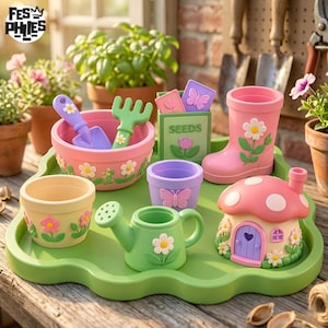 May include: A green tray holding a collection of gardening-themed items including a pink bowl with a shovel and rake, a seed box, a pink boot planter, a yellow pot, a green watering can, a purple pot, and a pink mushroom-shaped house.