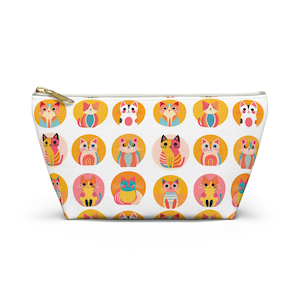 May include: White zippered cosmetic bag featuring a repeating pattern of colorful cartoon cats in orange, pink, and blue circles. The cats have various designs and expressions. The zipper is gold.