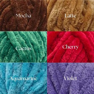 May include: Five balls of yarn in different colors: mocha, latte, cactus, cherry, and aquamarine. The yarn is a soft, fuzzy texture.