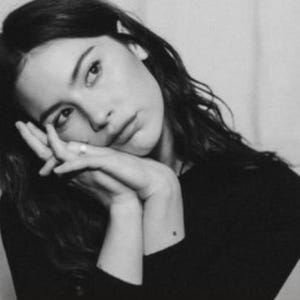 May include: Black and white portrait of a woman with long, wavy hair. The image is divided into three sections, with the name "GRACIE" in bold white letters in the top section and "ABRAMS" in the middle section.