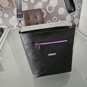 Handmade shoulder bag made of black faux leather with floral pattern