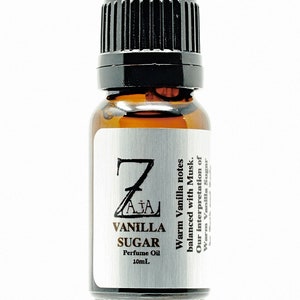May include: A small brown glass bottle with a black cap. The label is silver and says "Z AJA VANILLA SUGAR Perfume Oil 10mL" and "Warm Vanilla notes balanced with Musk. Our interpretation of Warm Vanilla Sugar."